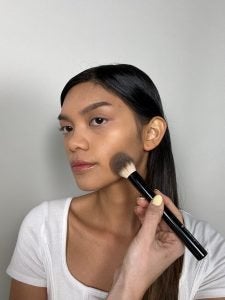 girl with bronzer being applied to face